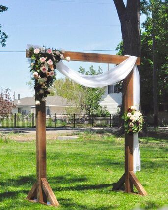 Wedding Arch Rentals delivered by NCW Event Rentals in Tri-Cities, Washington — Cedar wedding arch set up for an outdoor ceremony