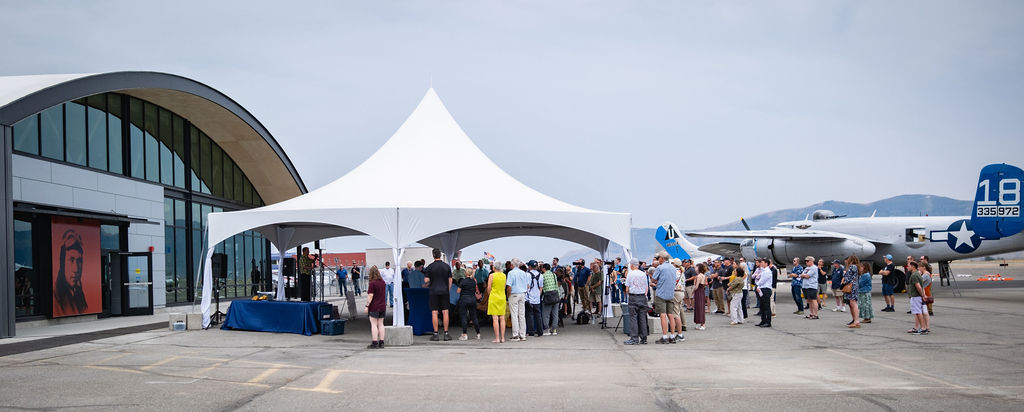 Sound & AV Rentals delivered by NCW Event Rentals in Cle Elum, Washington — Corporate event stage with speakers and presentation screen inside a tent in Eastern Washington