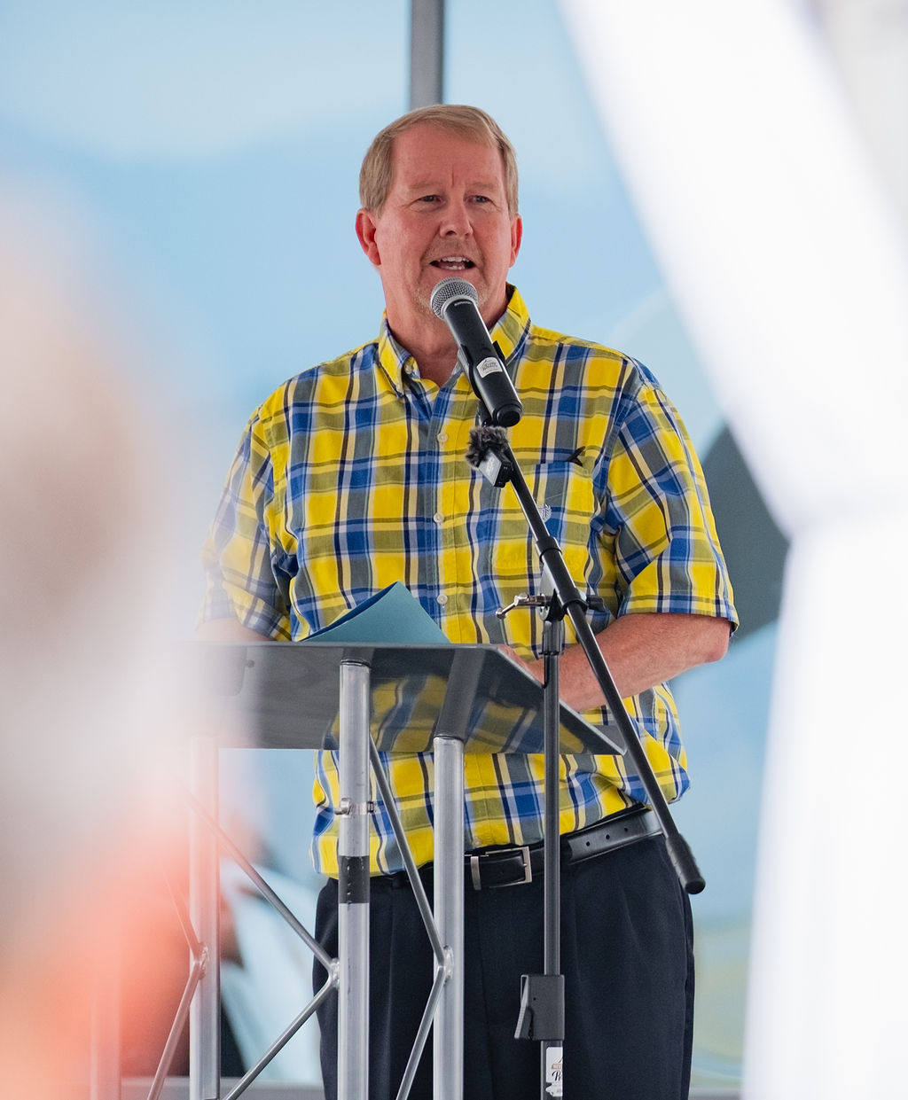 Speaker at a rented podium with microphone during a corporate program in Eastern Washington
