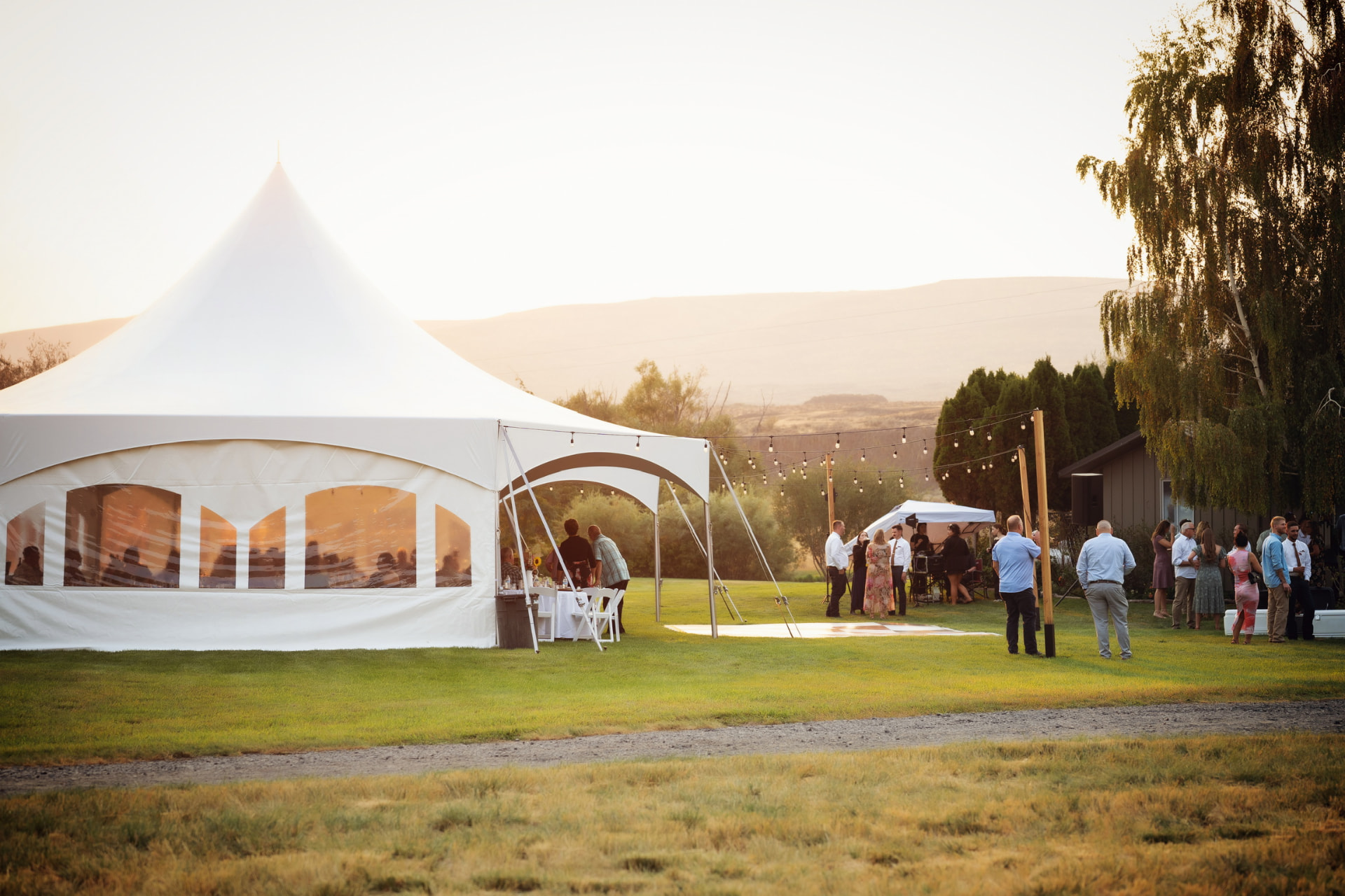 Tent rental interior with banquet tables and chairs set for dinner in Eastern Washington