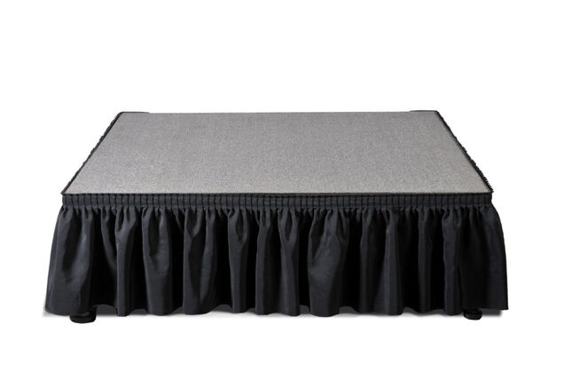 Black stage skirting on a BilJax modular stage deck — event rental serving Yakima, Ellensburg and the Tri-Cities, Washington