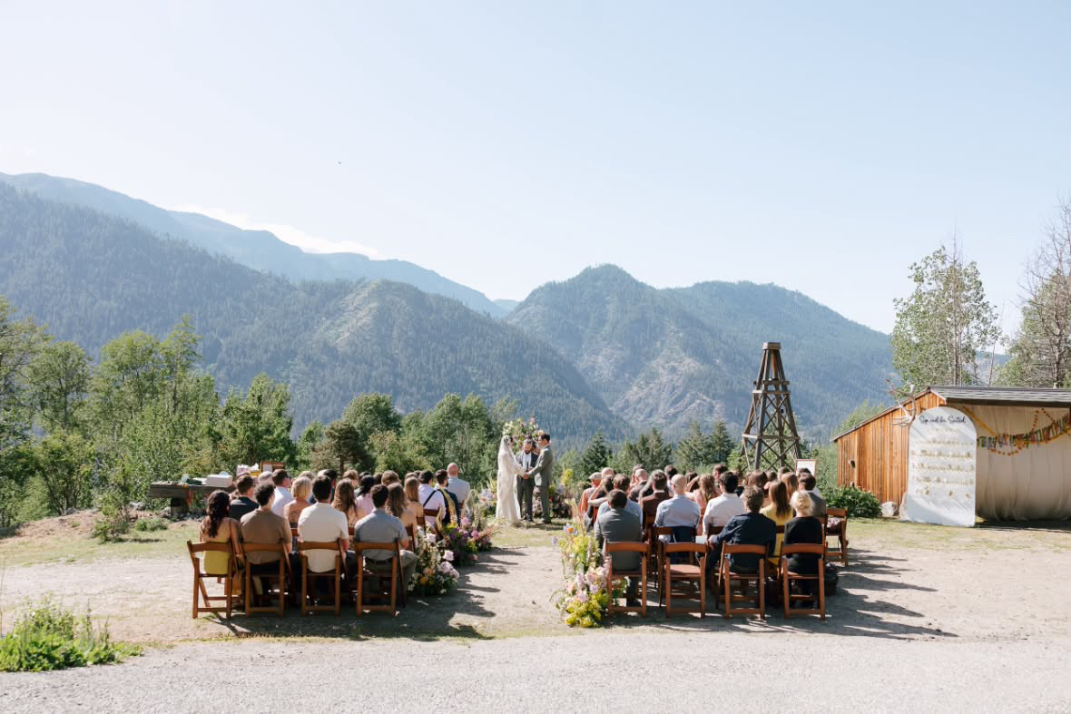 Wood folding chair rentals arranged for an outdoor mountain wedding ceremony near Leavenworth Washington