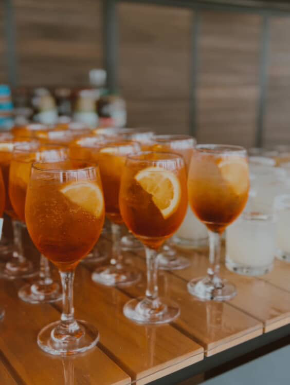 Stemmed wine glass rentals with orange slices set out for a signature cocktail hour in Cle Elum, Washington