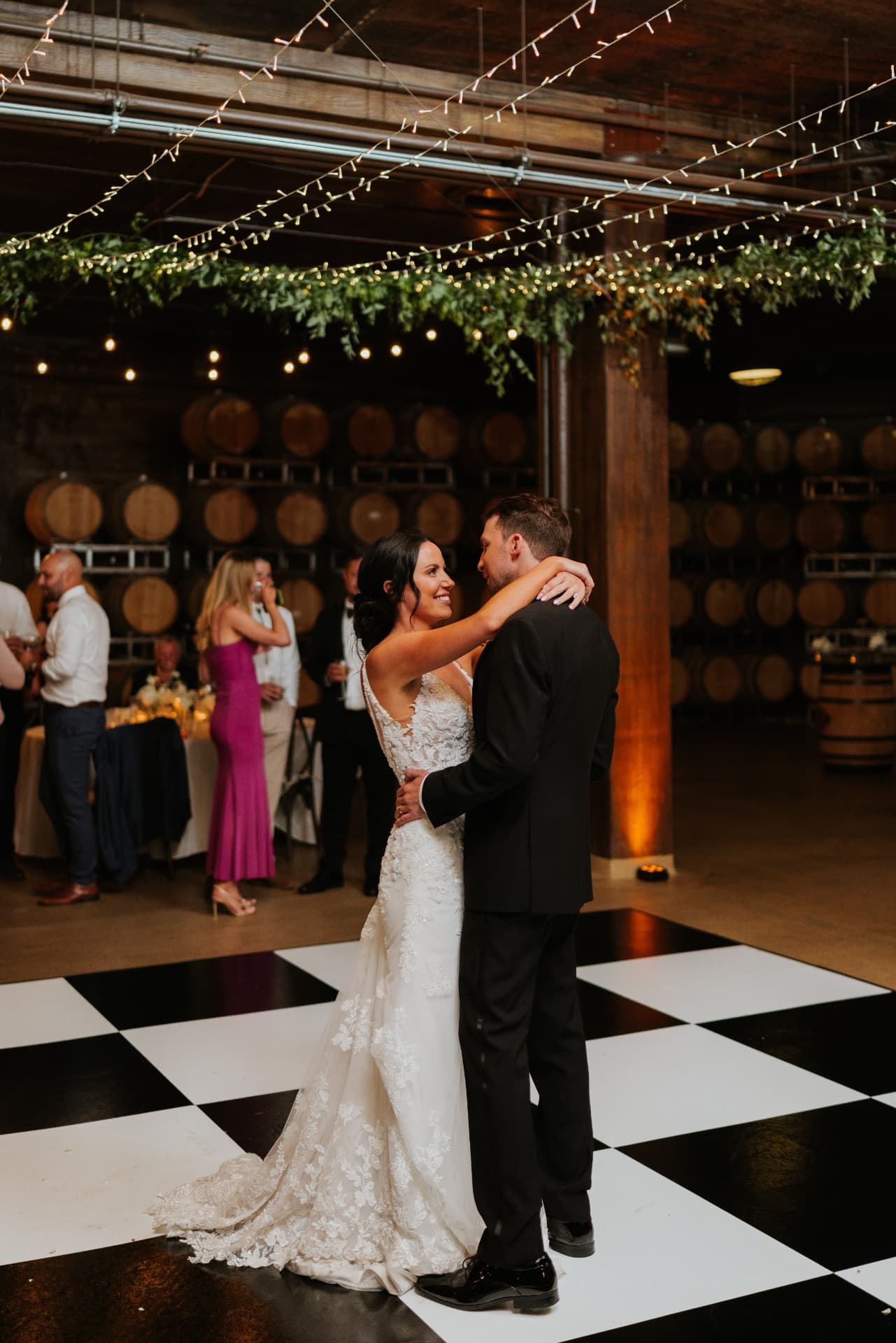 Black and white checkered dance floor installed in the wine barrel room at Swiftwater Cellars, Suncadia, Cle Elum WA wedding reception
