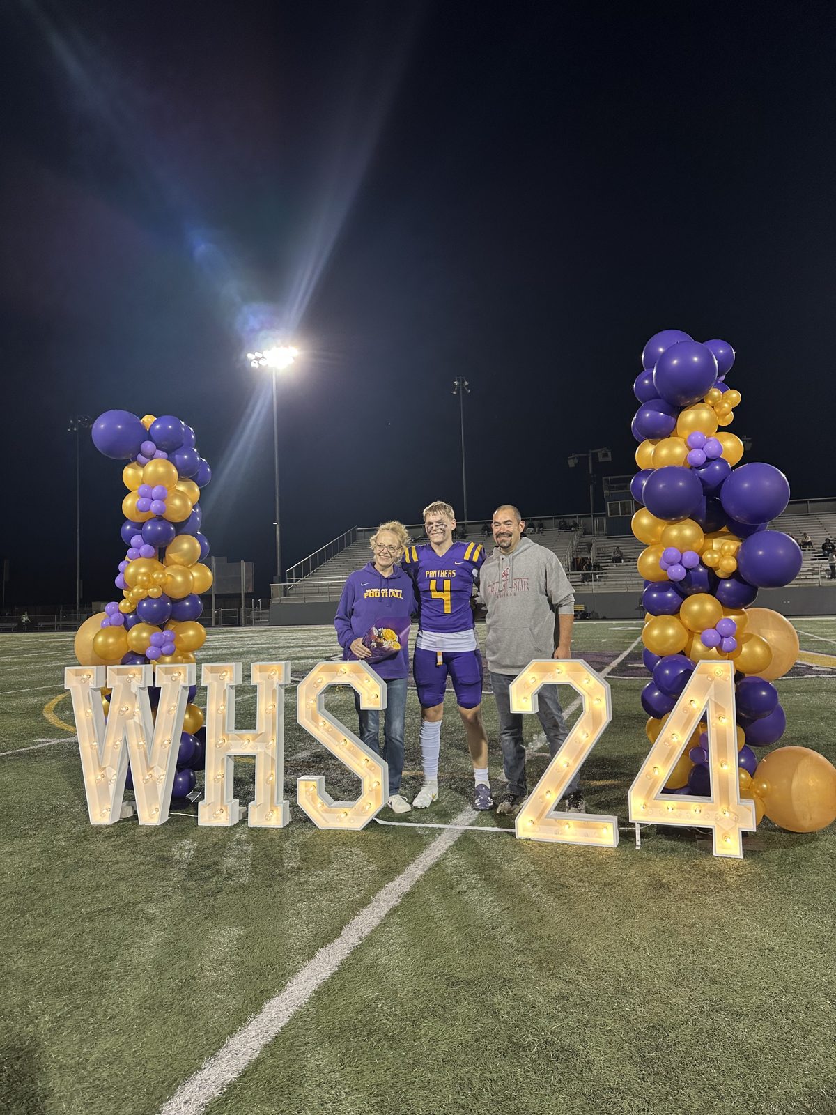 WHS 24 lit marquee numbers and letters on a football field for senior night photos