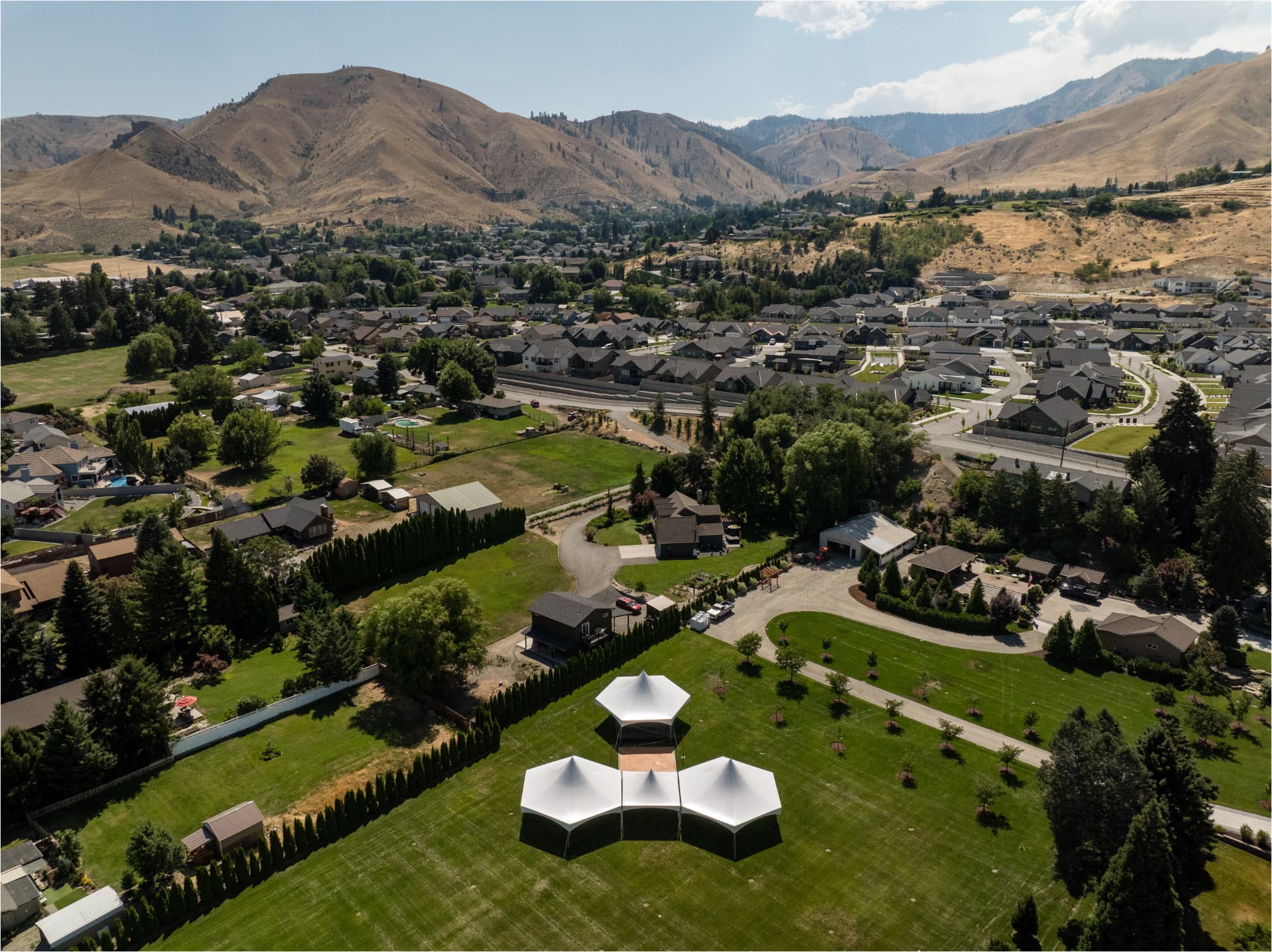 Aerial view of connected high-peak tents installed by NCW Event Rentals in the Wenatchee Valley